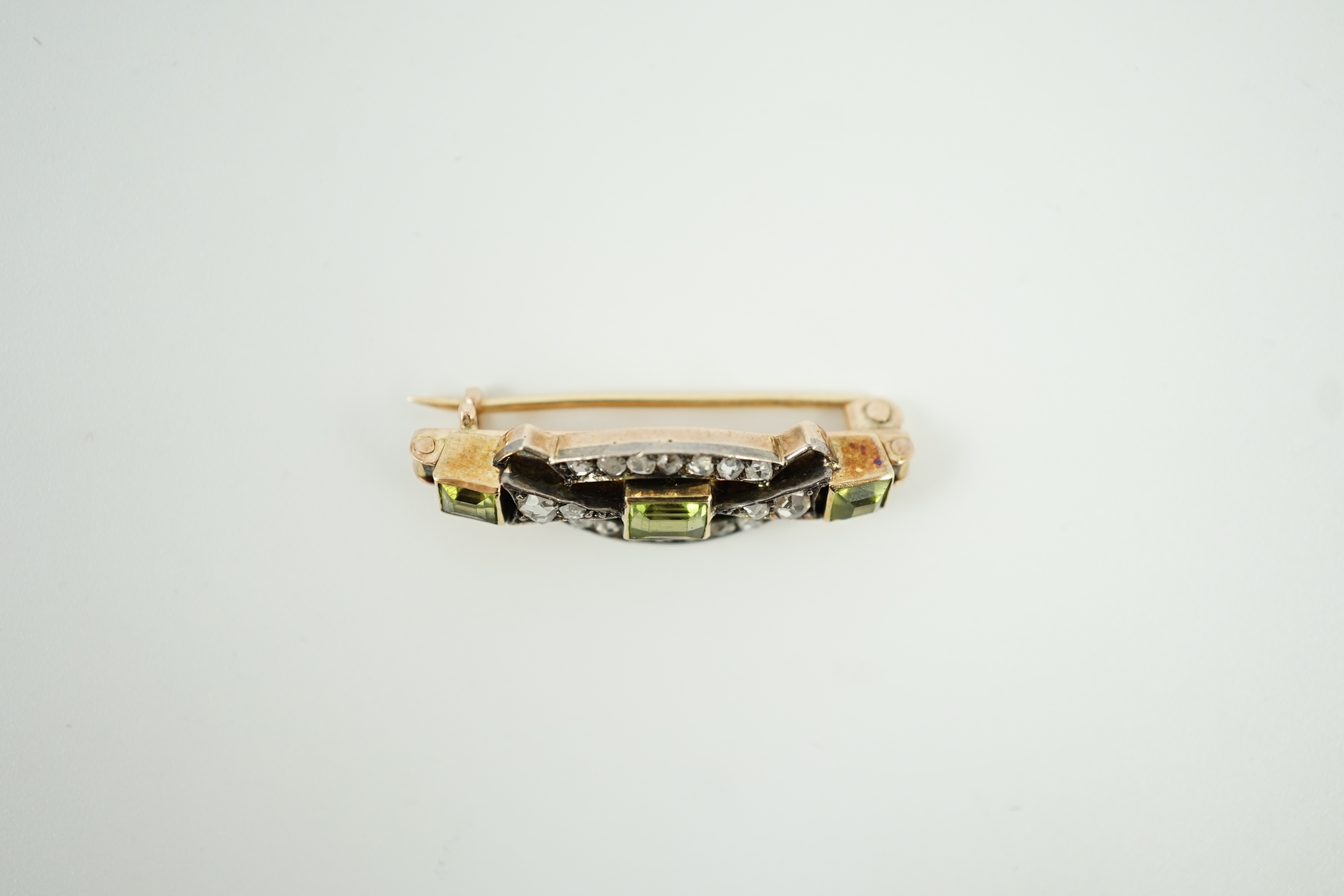 A late Victorian yellow metal, peridot and rose cut diamond set brooch, 31mm, gross weight 4.9 grams.